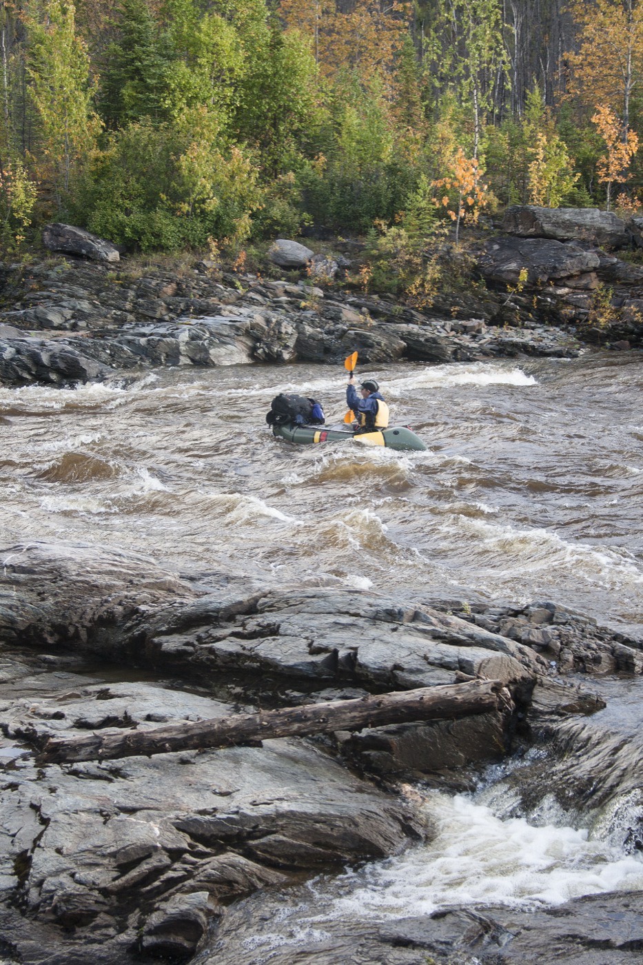 Rafter running whitewater rapids on an Alaska river