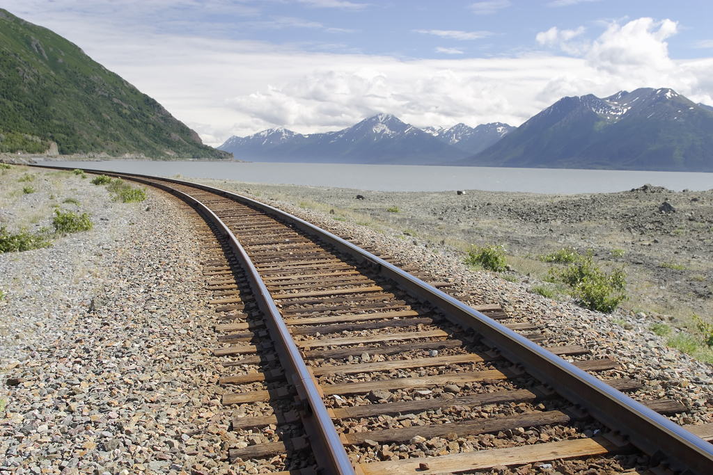 Alaska Railroad train running along the shore of Turnagain Arm